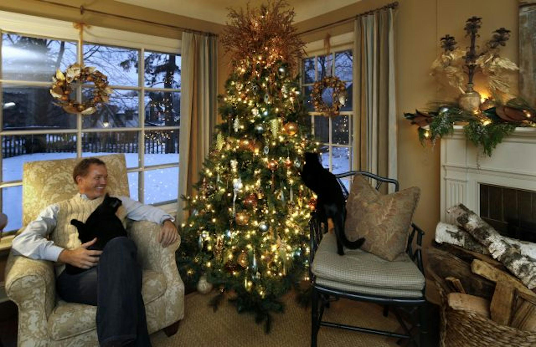 Interior designer John Lassila trims his tree with festive copper-colored beaded branches and a mix of robin's egg blue, silver and gold ornaments.