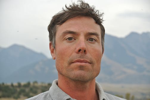 photo of author Callan Wink, with a mountain in the background