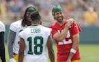 Aaron Rodgers shares a laugh with wide receivers Davante Adams and Randall Cobb on Saturday.
