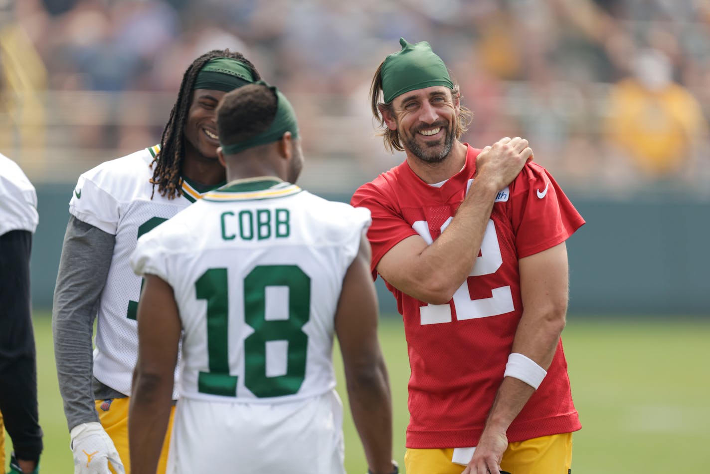 Aaron Rodgers shares a laugh with wide receivers Davante Adams and Randall Cobb on Saturday.