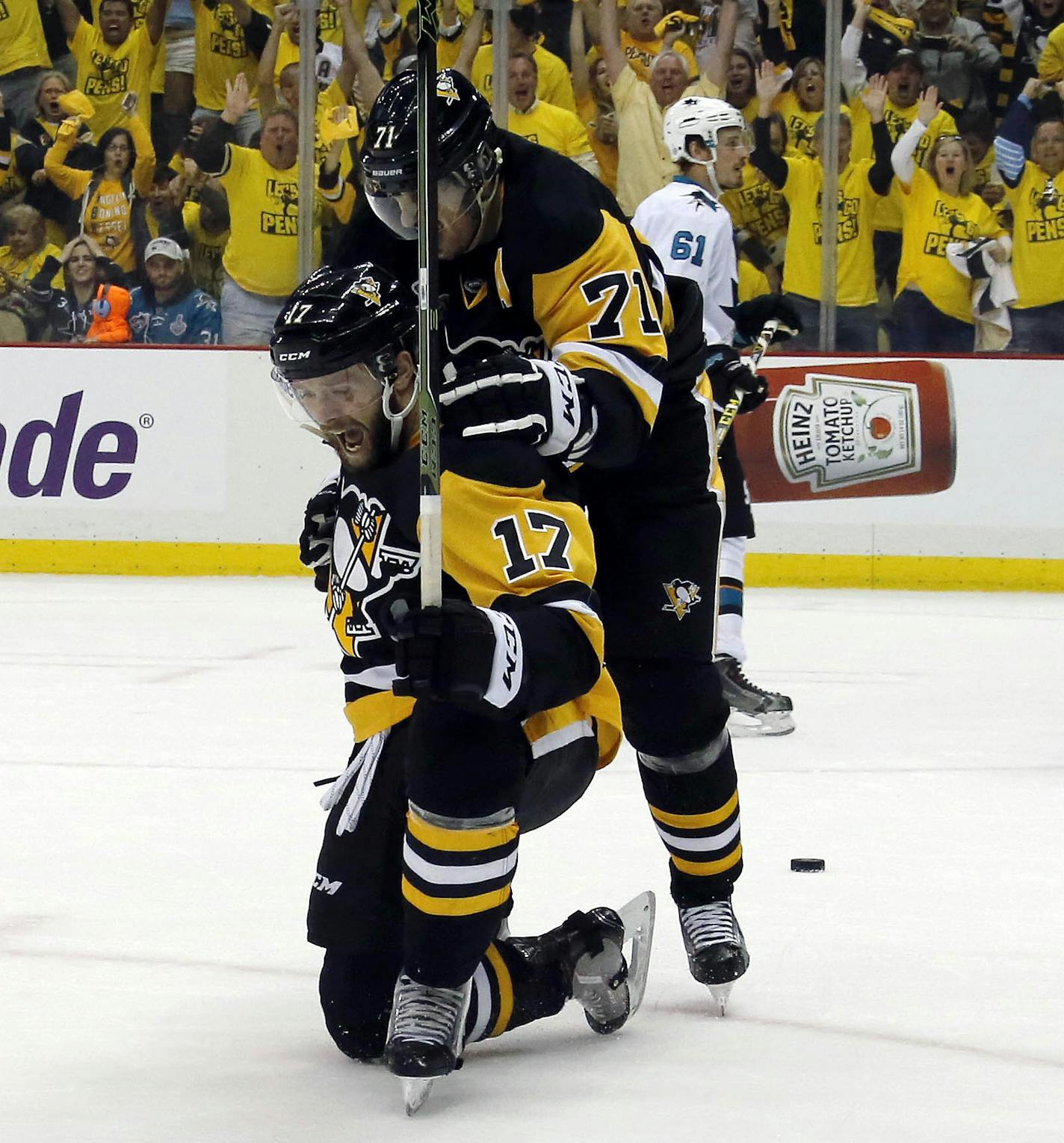 Pittsburgh Penguins' Bryan Rust (17) celebrates with Evgeni Malkin (71) his goal against San Jose Sharks goalie Martin Jones (31) during the first period in Game 1 of the Stanley Cup final series Monday, May 30, 2016, in Pittsburgh. (AP Photo/Keith Srakocic)