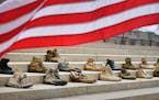 Twenty three pairs of boots on the front steps of the Capitol on the first day of Operation 23 to Zero. ] GLEN STUBBE &#xa5; glen.stubbe@startribune.c