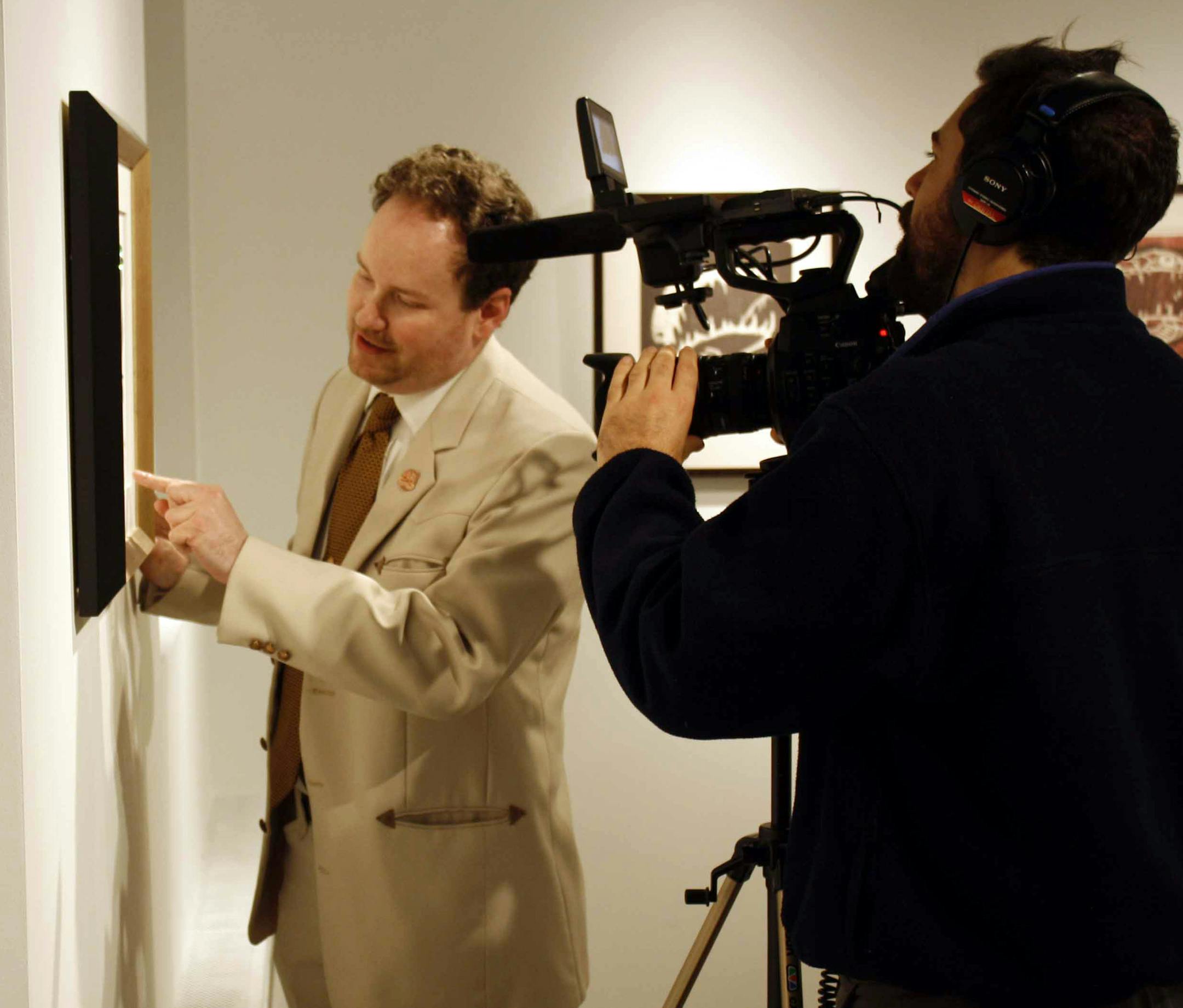 Filming at Instinct Gallery, Mpls artist Rob McBroom, left, explains his work to Brian Davis &#x201a;&#xc4;&#xec; at right. Davis is director of the new film called &#x201a;&#xc4;&#xfa;The Million Dollar Duck.&#x201a;&#xc4;&#xf9; (photo courtesy Instinct Gallery)