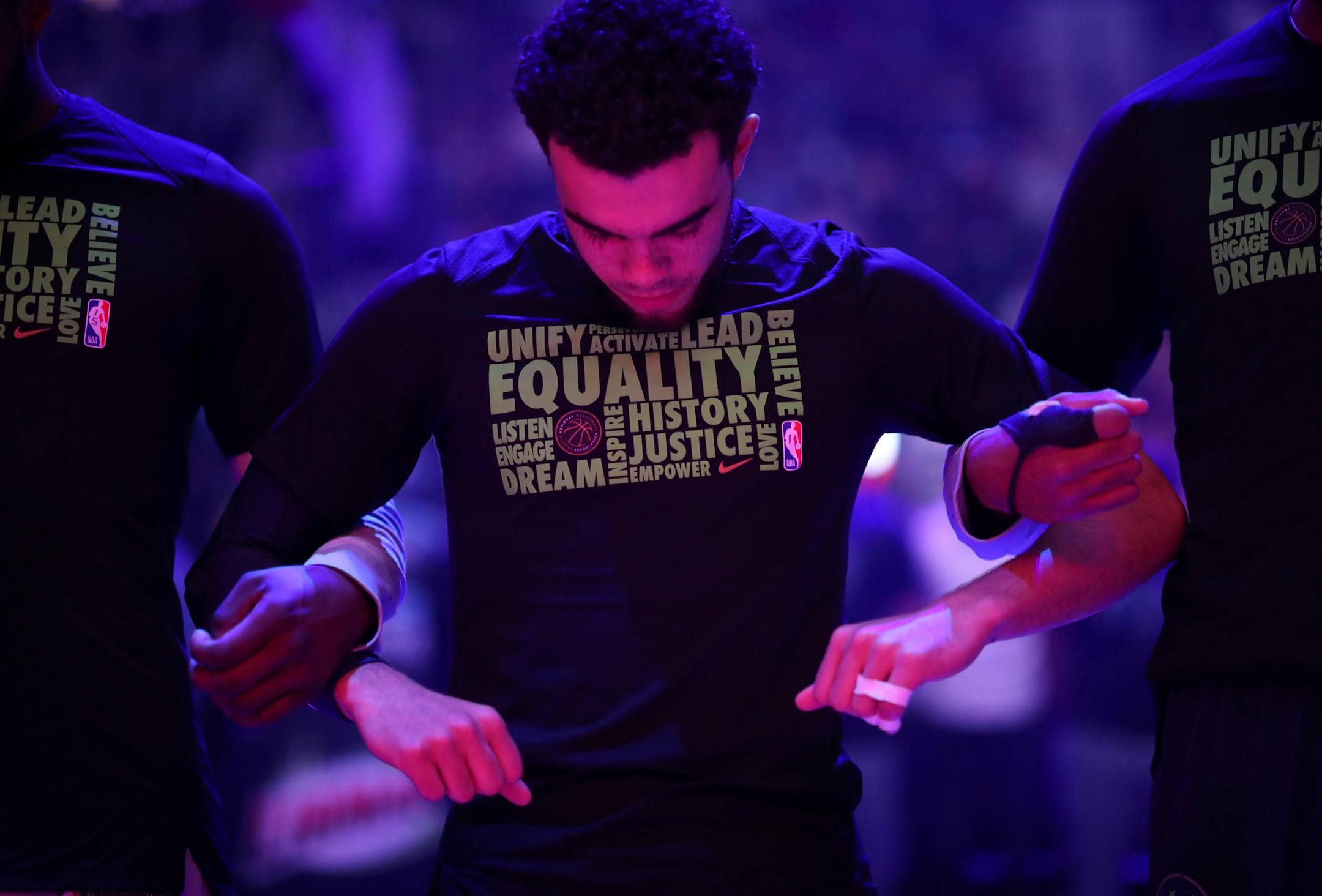 The Minnesota Timberwolves, including guard Tyus Jones, linked arms for the singing of the national anthem before the game.