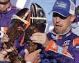 Driver Denny Hamlin reacted after being handed a lobster after winning the NASCAR Cup Series 301 auto race at the New Hampshire Motor Speedway on Sund