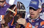 Driver Denny Hamlin reacted after being handed a lobster after winning the NASCAR Cup Series 301 auto race at the New Hampshire Motor Speedway on Sund