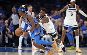 Timberwolves guard Anthony Edwards (5) defends against Thunder guard Shai Gilgeous-Alexander on Thursday night in Oklahoma City.