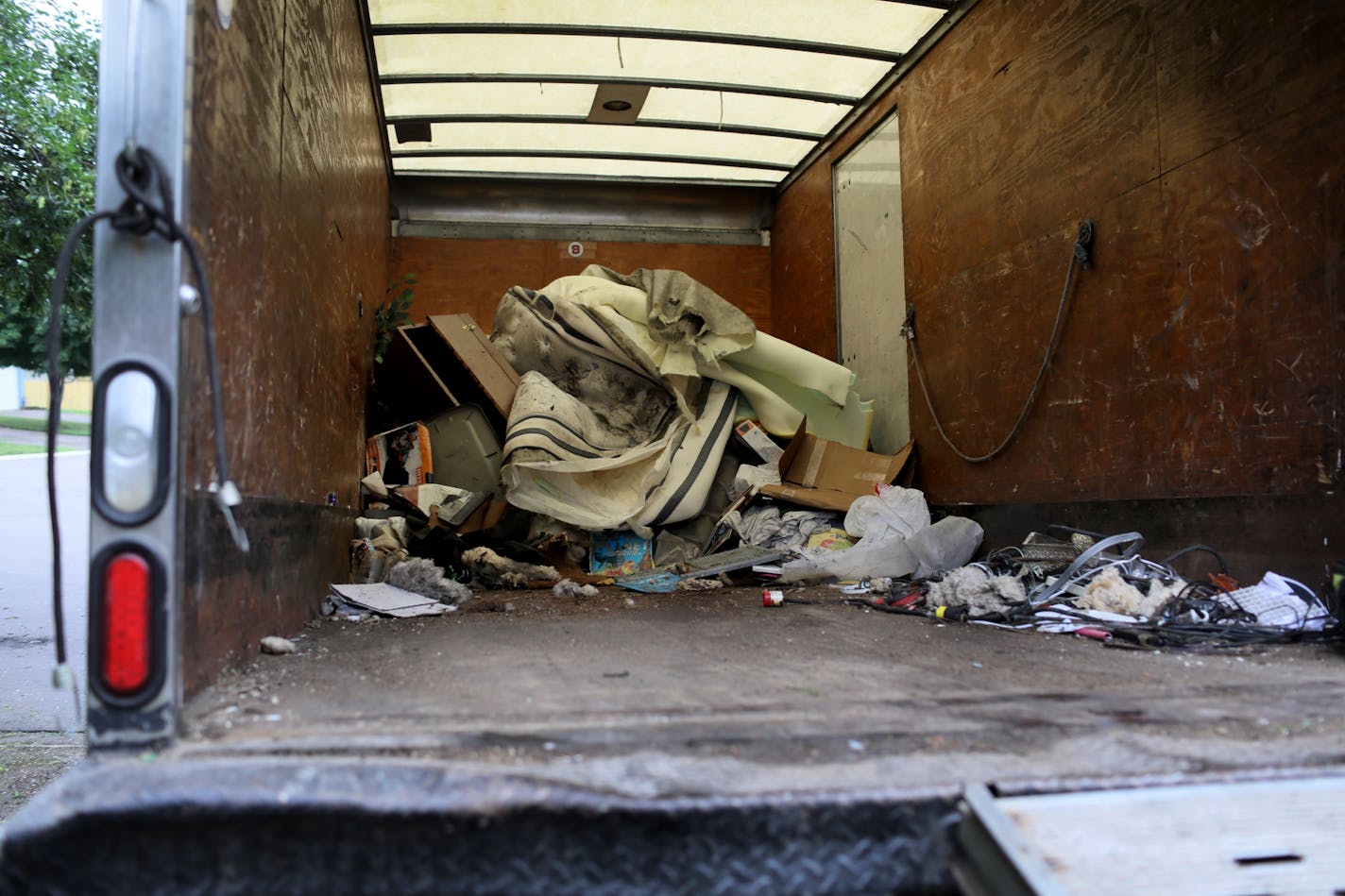 A missing 11-year-old Brooklyn Park girl was found safe Monday, but authorities removed three other children from the home, which they have deemed unfit. Here, toys ad other belongings from the home were removed and placed inside a Kaba Junk Removal truck Tuesday, June 19, 2018, in Brooklyn Park, MN.