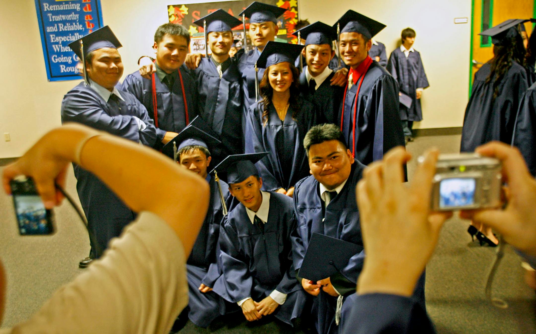 A group of the Hmong Academy graduates posed for photos taken by friends. The school started with 200 students in 2004 and is expected to have 600 to 700 by 2010.