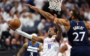 Thunder forward Jalen Williams drives against Wolves center Rudy Gobert on Monday night at Target Center.