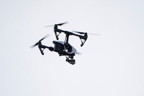 FILE - In this Thursday, Aug. 8, 2019, file photo, a drone flies in a residential neighborhood in Upper Moreland, Pa. Researchers say that the recreational drone market could come together with the wearables market to produce what may one day be a fixture in personal health and wellness: fitness drones. (AP Photo/Matt Rourke, File)