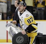 Pittsburgh Penguins center Sidney Crosby celebrates with the Stanley Cup after defeating the Nashville Predators 2-0 in Game 6 of the NHL hockey Stanl