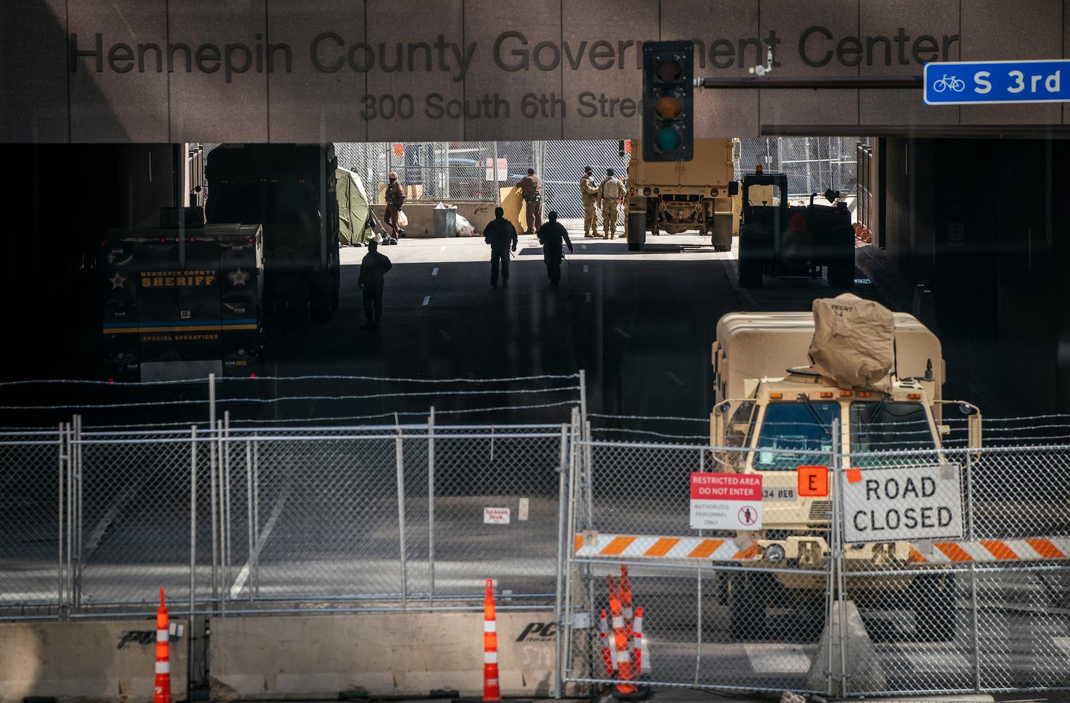 Minnesota National Guard troops and other law enforcement officers stood guard outside the heavily fortified Hennepin County Government Center.