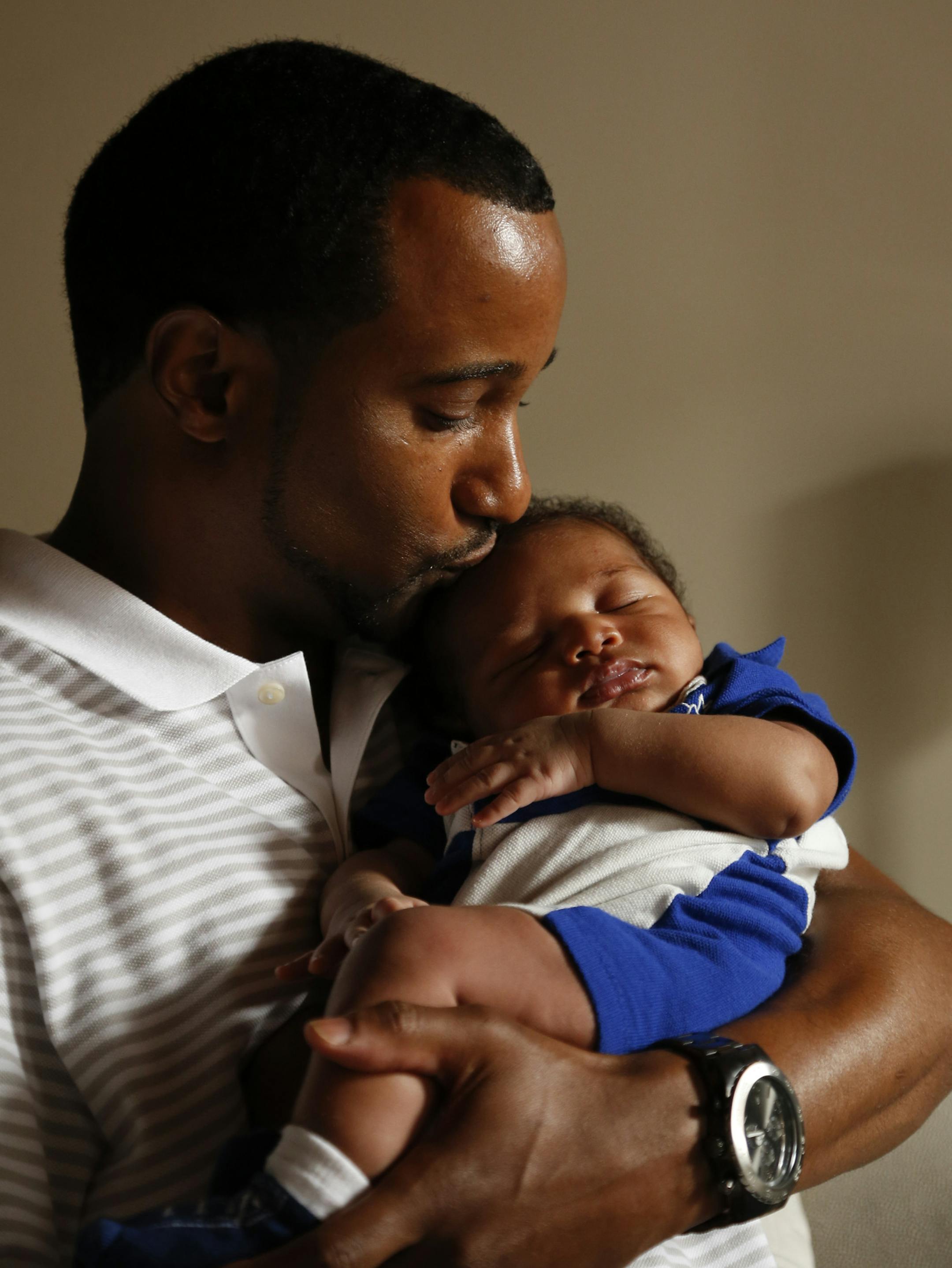 Courtney Henry with his son, Courtney Jr. ] JEFF WHEELER ‚Ä¢ jeff.wheeler@startribune.com Courtney Henry and his son, Courtney Jr., photographed Tuesday afternoon, May 27, 2014 in their St. Paul home.