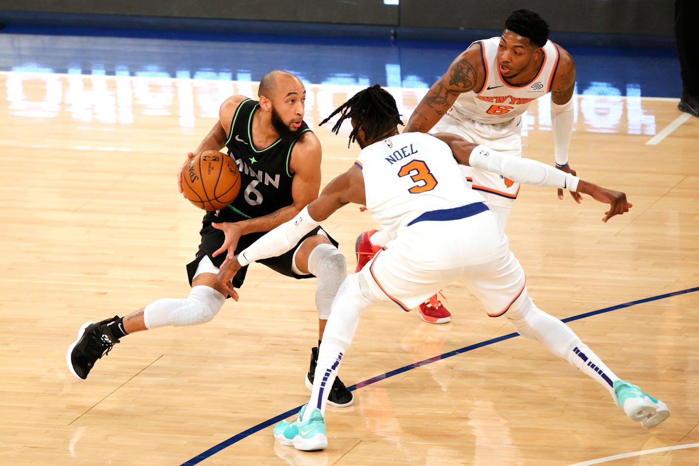 Minnesota Timberwolves' Jordan McLaughlin (6) dribbles as New York Knicks' Nerlens Noel (3) and Elfrid Payton (6) defend during the first half of an NBA basketball game Sunday, Feb. 21, 2021, in New York. (Sarah Stier/Pool Photo via AP)