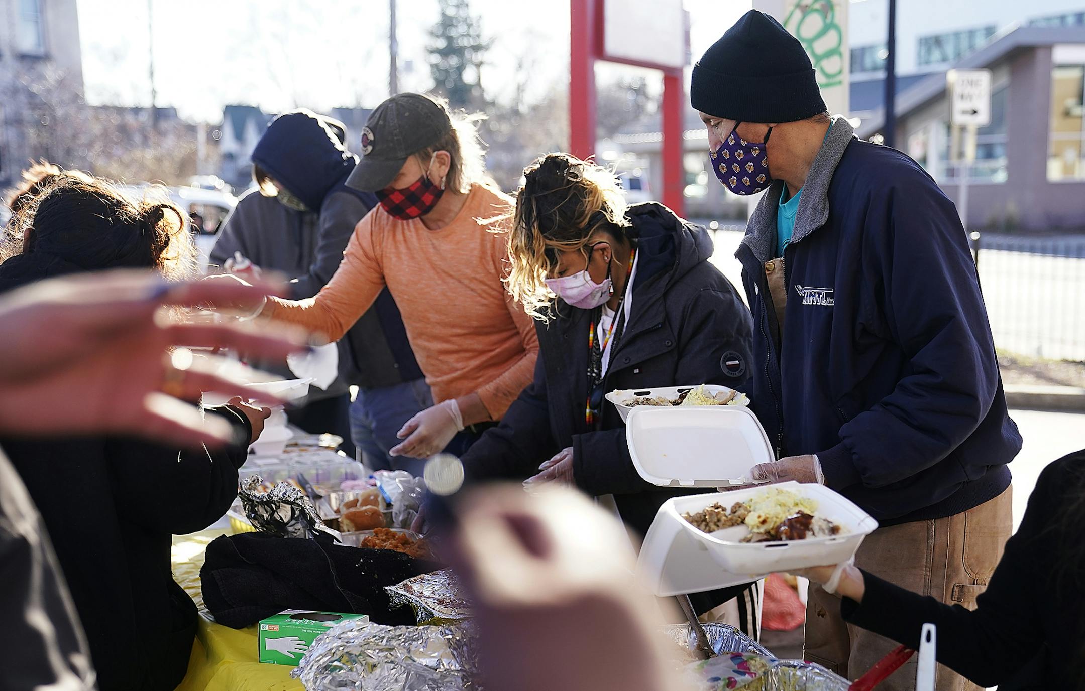 Allen Touche, 48, rear right, helped scoop food on plates for hungry Native residents in the parking lot of a closed down Speedway gas station along Bloomington Ave., where weekly on Saturdays he journeys to help feed homeless in Minneapolis. Clothes are collected and a meal given out by a coalition of Native and non-native community members who represent no one particular organization but look at those in need as relatives merely needing some outreach.