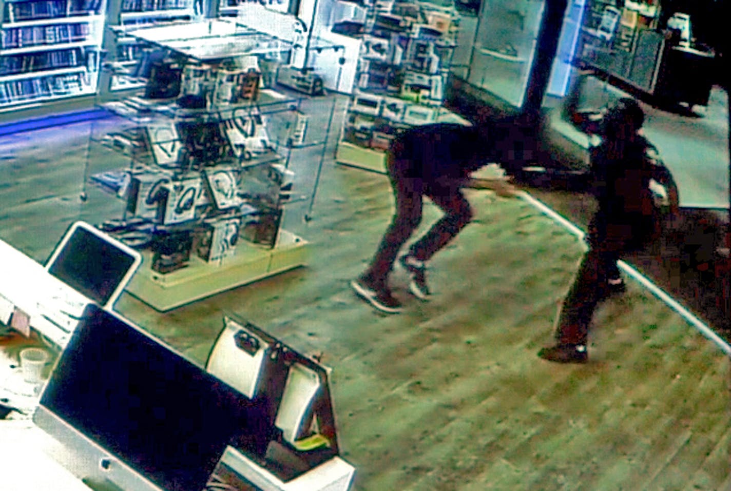 Frame grab surveillance video from the St. Cloud mall attack shows Dahir Adan, right, attacking with knife a mall worker at the beginning of his rampage.