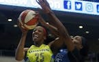 Dallas forward Glory Johnson tried to get off a shot against Lynx center Sylvia Fowles in the first quarter of Minnesota's 89-87 victory in Arlington,