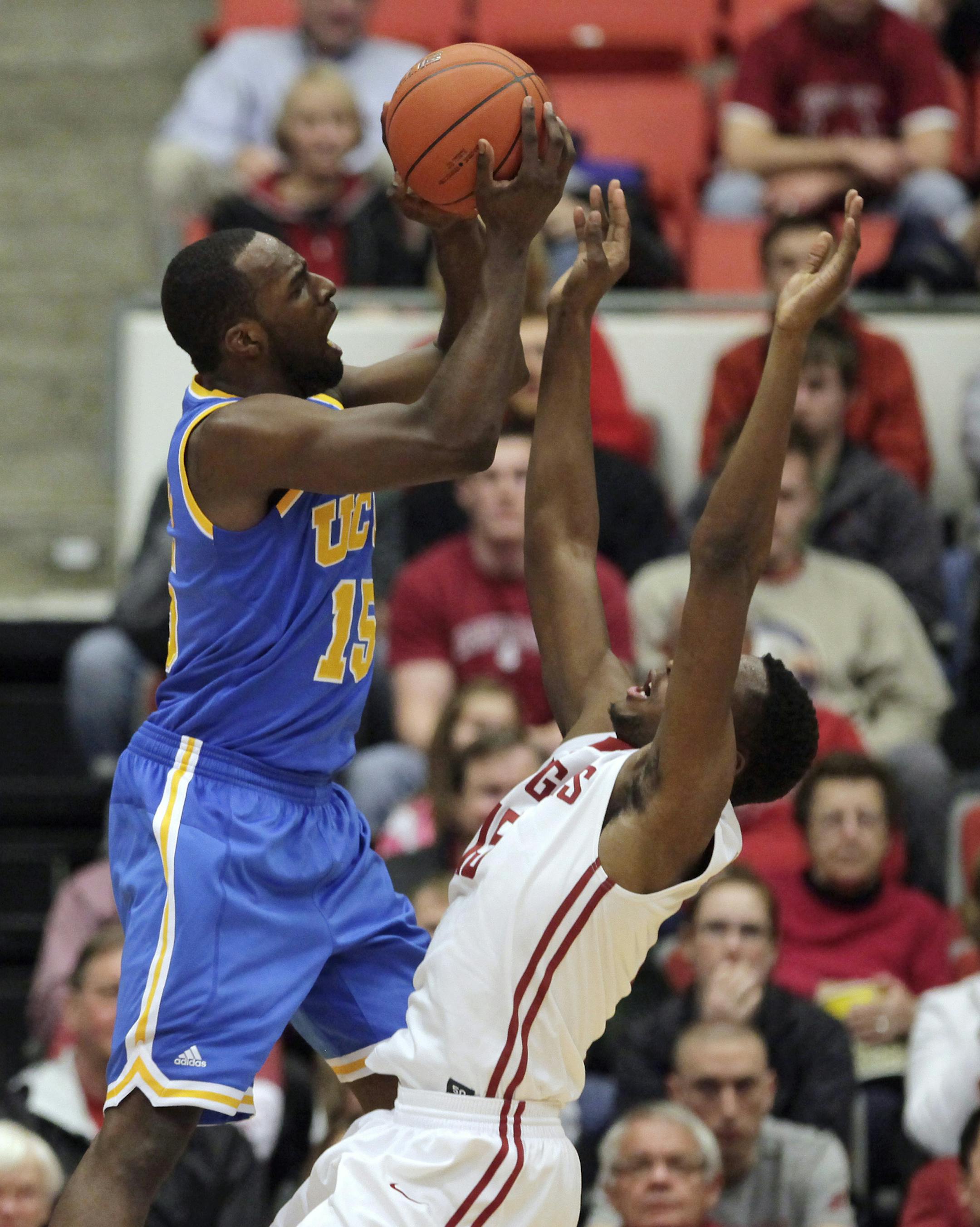 UCLA guard Shabazz Muhammad, center, draws a foul and scores on this shot over Washington State forward Junior Longrus, right, during the first half of an NCAA college basketball game Wednesday, March 6, 2013, in Pullman, Wash. (AP Photo/Dean Hare)