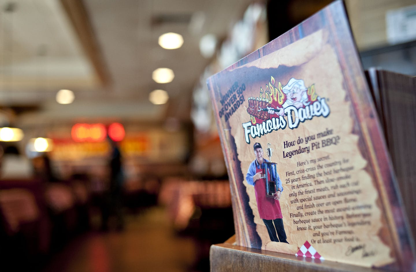 A menu sits at the hostess stand of a Famous Dave's of America Inc. franchise restaurant in Peoria, Illinois, U.S., on Thursday, March 21, 2013. Famous Dave's of America is a chain of barbecue restaurants started in 1994 that has 191 locations in 34 U.S. states and one Canadian province. Photographer: Daniel Acker/Bloomberg