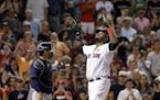 Boston Red Sox designated hitter David Ortiz gestures at the plate in front of Minnesota Twins catcher Kurt Suzuki after hitting a two-run homer in th