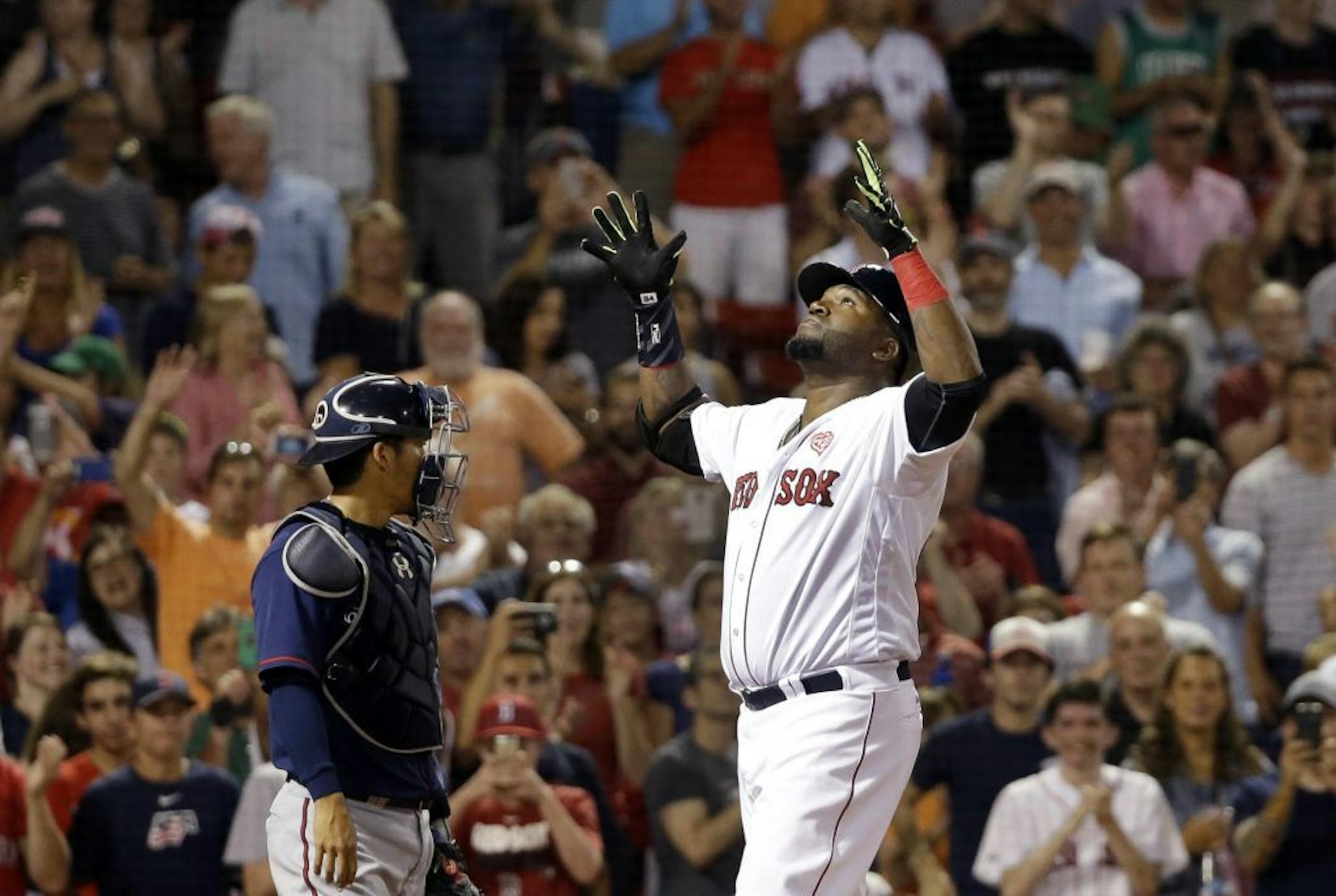 Boston Red Sox designated hitter David Ortiz gestures at the plate in front of Minnesota Twins catcher Kurt Suzuki after hitting a two-run homer in the eighth inning of a baseball game at Fenway Park, Thursday, July 21, 2016, in Boston.
