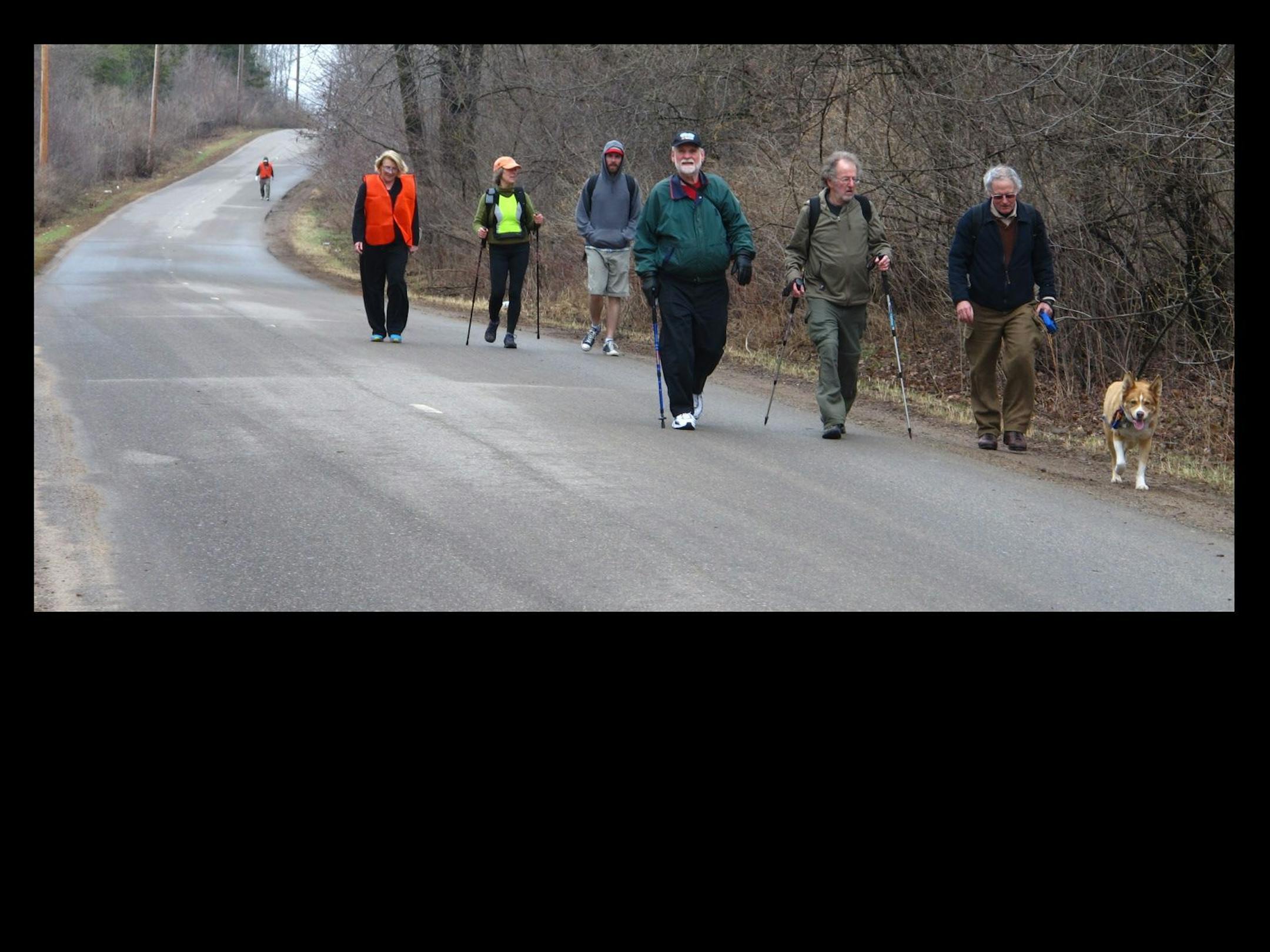 Tom Warth, front center with poles, has raised money for Books for Africa for years by walking great distances. Here he's on his way to Scandia on the first leg of a 50-mile journey.