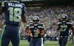 Seattle quarterback Russell Wilson congratulated Seahawks wide receiver Kasen Williams on catching his touchdown pass in the first quarter.