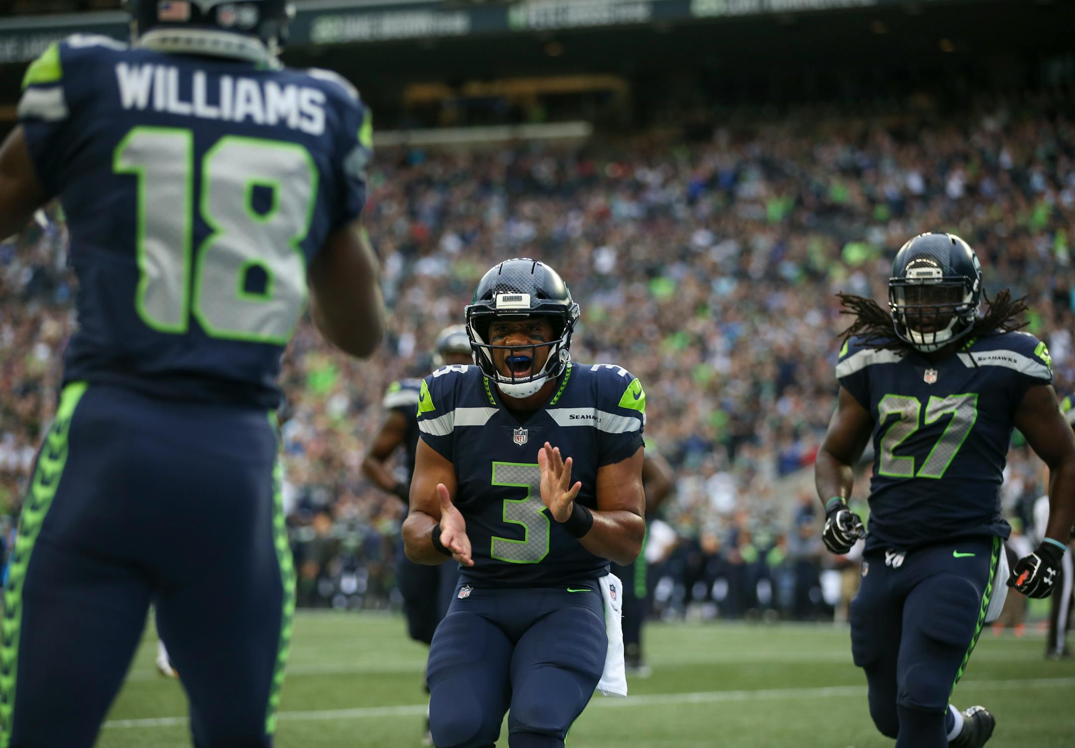 Seattle quarterback Russell Wilson congratulated Seahawks wide receiver Kasen Williams on catching his touchdown pass in the first quarter.