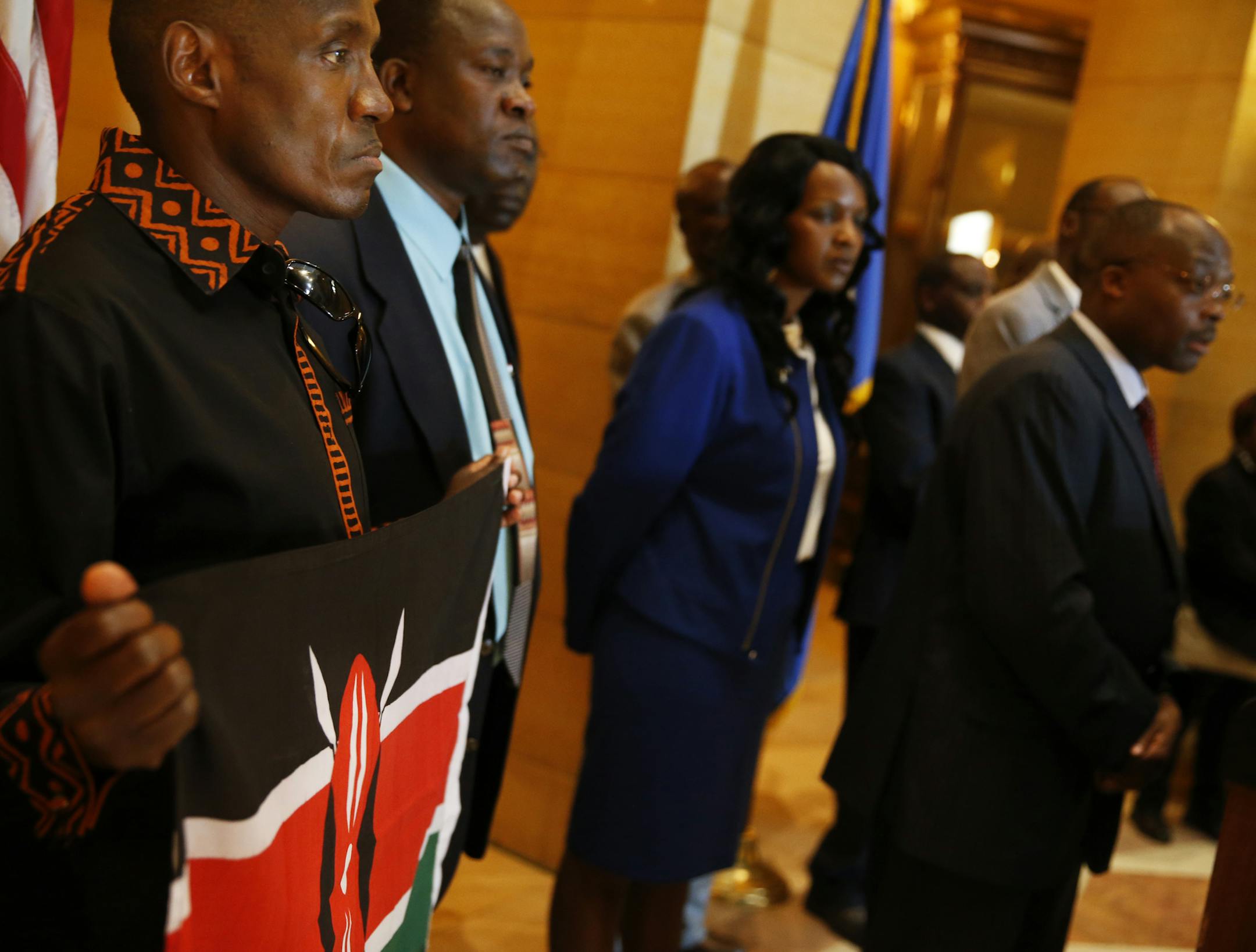 In the rotunda of the state capitol in St. Paul, Kihanya Mwaura held the Kenyan flag in solidarity with other Minnesotan Kenyans who were taking a stand against the attacks by Al Shabab in the shopping mall in Nairobi. Mwaura learned that his cousin's husband was killed in the Westgate mall.]richard tsong-taatarii/rtsong-taataarii@startribune.com