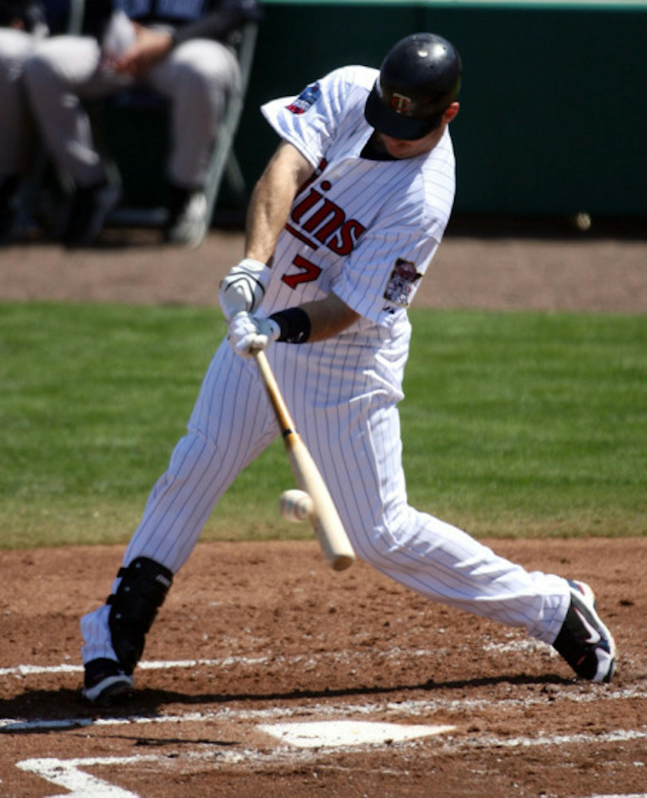 FORT MYERS, FL - MARCH 07:  Joe Mauer #7 of the Minnisota Twing hits a single against the New York Yankees at Lee County Sports Complex  on March 7, 2010 in Fort Myers, Florida.  (Photo by Marc Serota/Getty Images)