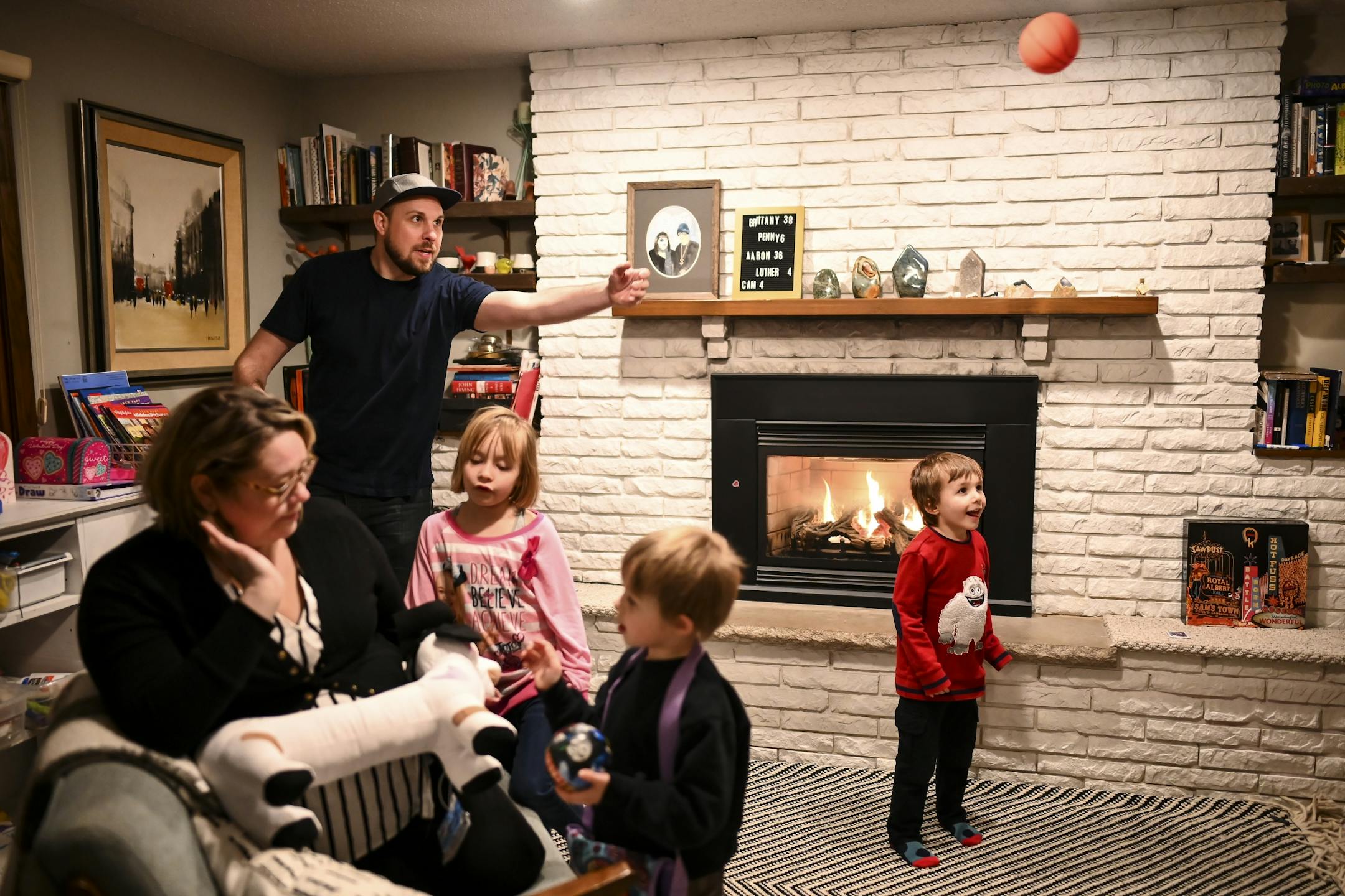Aaron and Brittany Mader played with their children, from left, Penny, 6, and twin brothers Lou and Cam, 4, Tuesday night in their home.