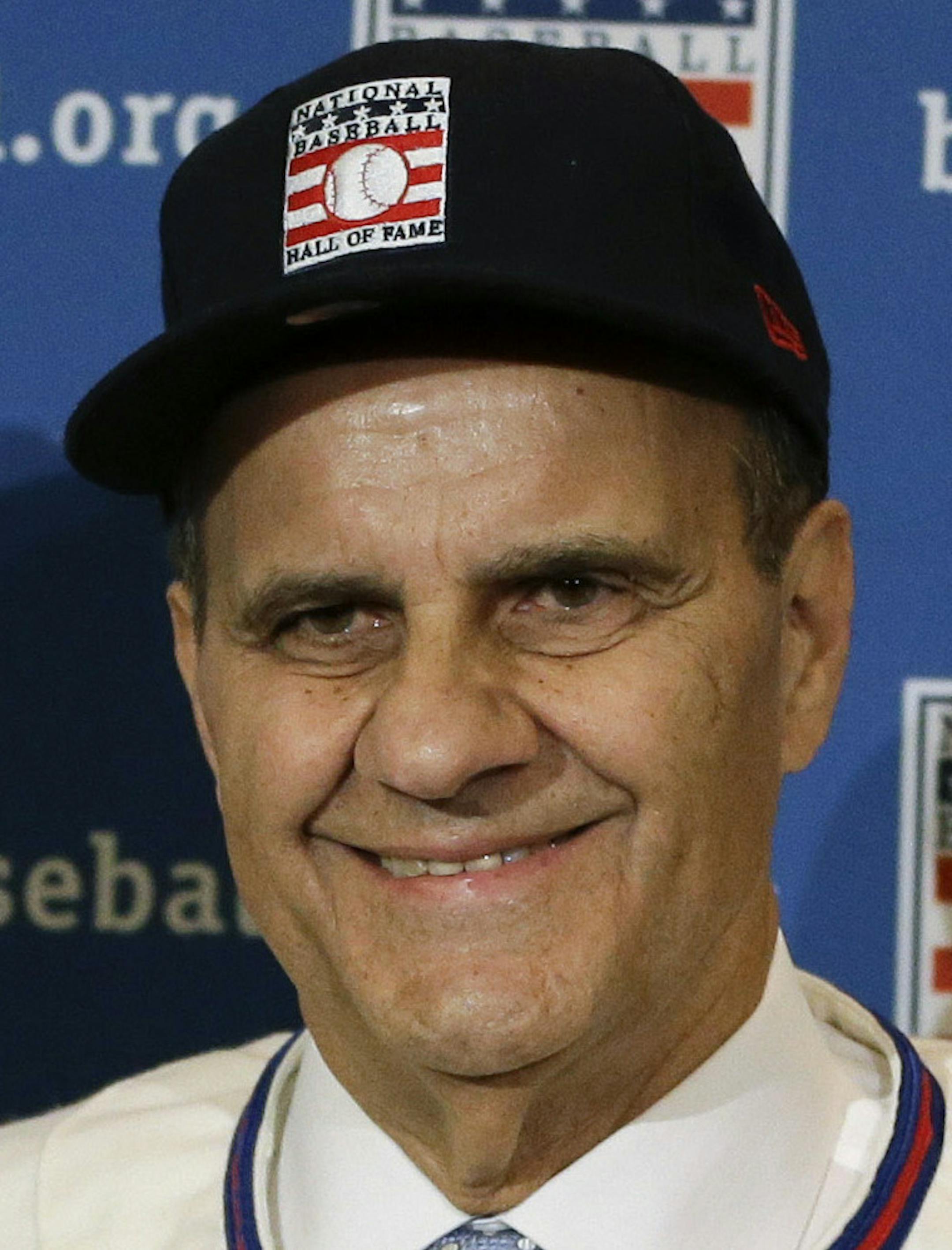 ADVANCE FOR WEEKEND EDITIONS, JULY 26-27 - FILE - In this Dec. 9, 2013 file photo, retired managers, from left, Tony La Russa, Joe Torre and Bobby Cox gather for a photo after it was announced that they were unanimously elected to the Baseball Hall of Fame, at a news conference during MLB winter meetings in Lake Buena Vista, Fla. Induction ceremonies are Sunday, July 27, 2014, in Cooperstown, N.Y. (AP Photo/John Raoux, File)