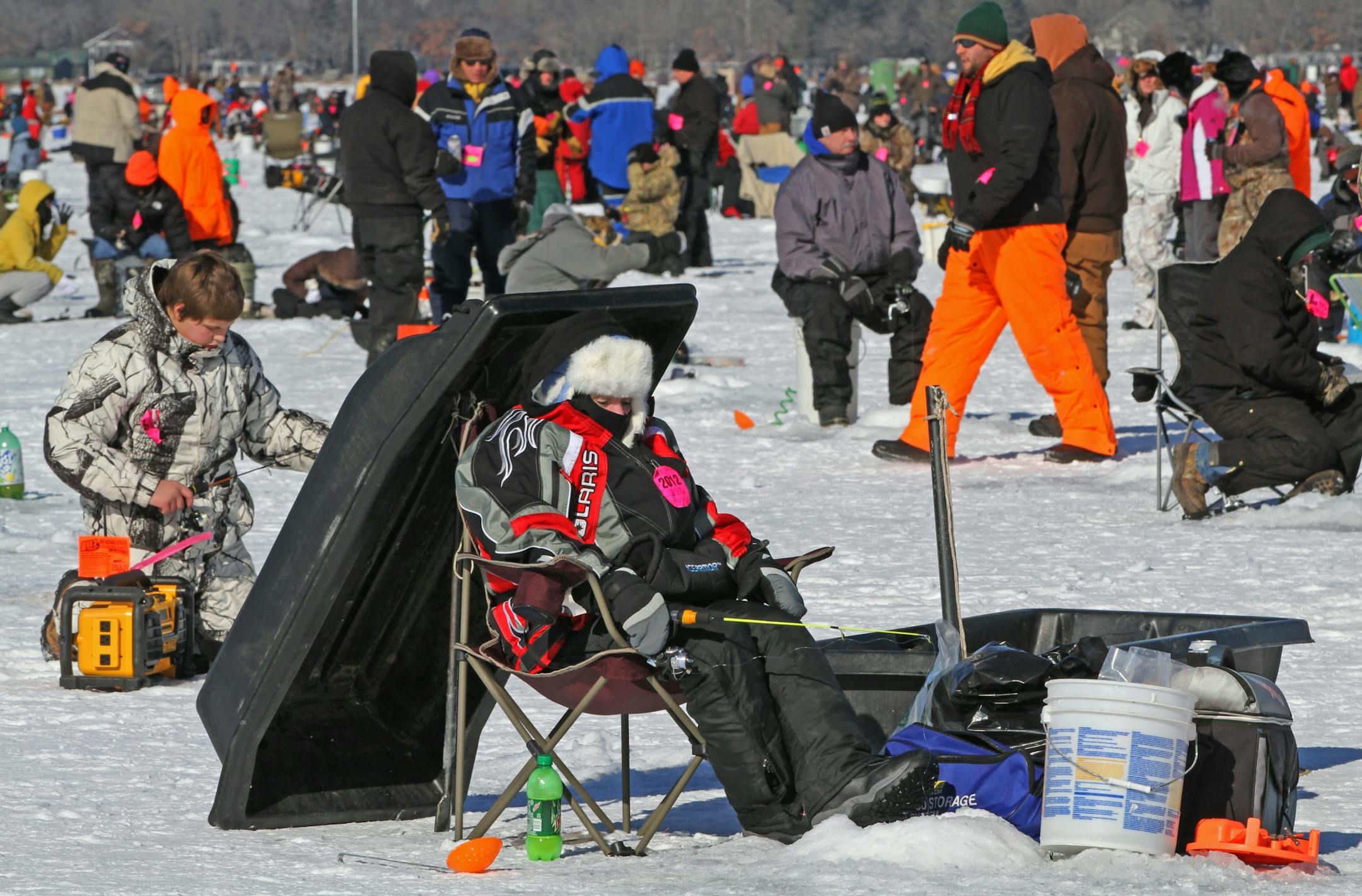 An angler used a sled as a wind break, trying to get shelter against the blowing winds on Gull Lake in 2012.