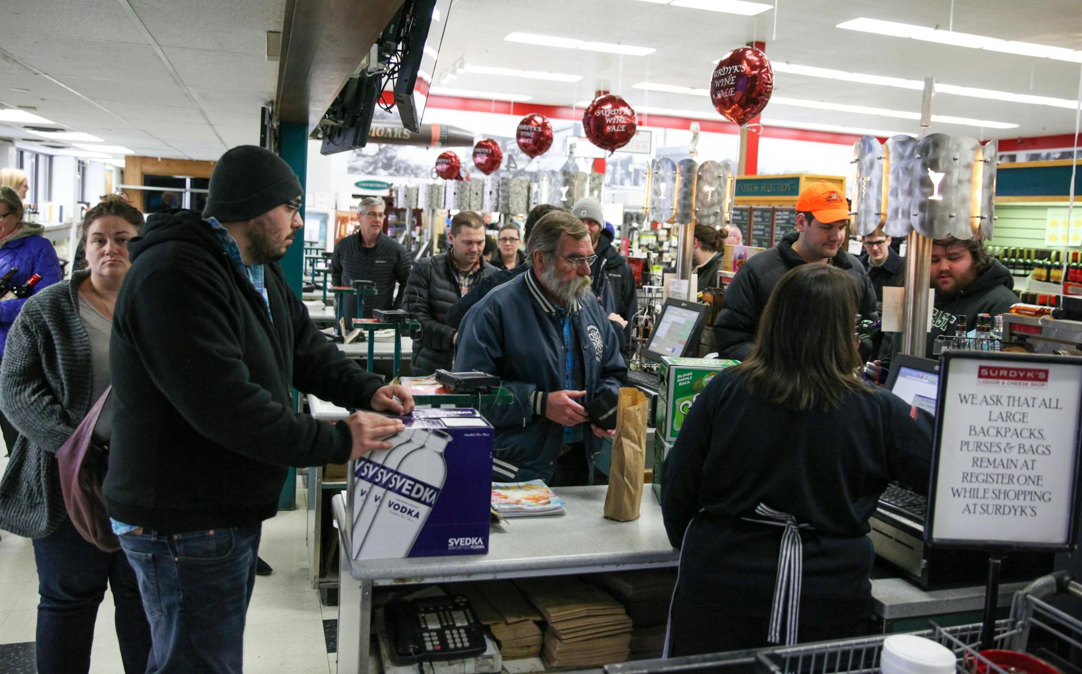 The casher desks are busy in the Surdyk's liquor store on Sunday. March 12, 2017.