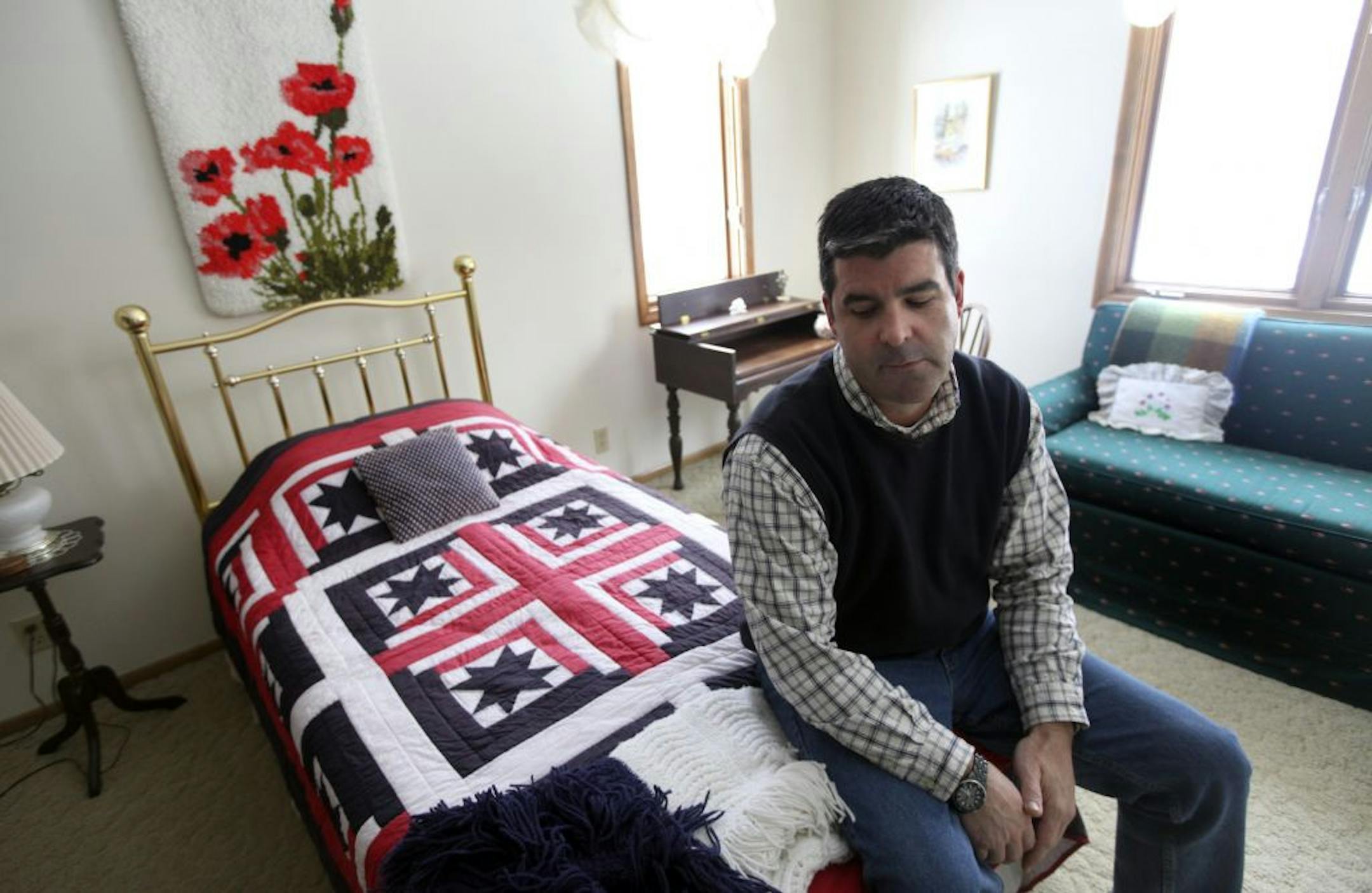 Chris Smith, 46, sat in the room his use to sneak out of when his was younger in Edina Min., Friday, March 2, 2012. Smith recently moved his parents to assisted living and his putting his childhood home on the market