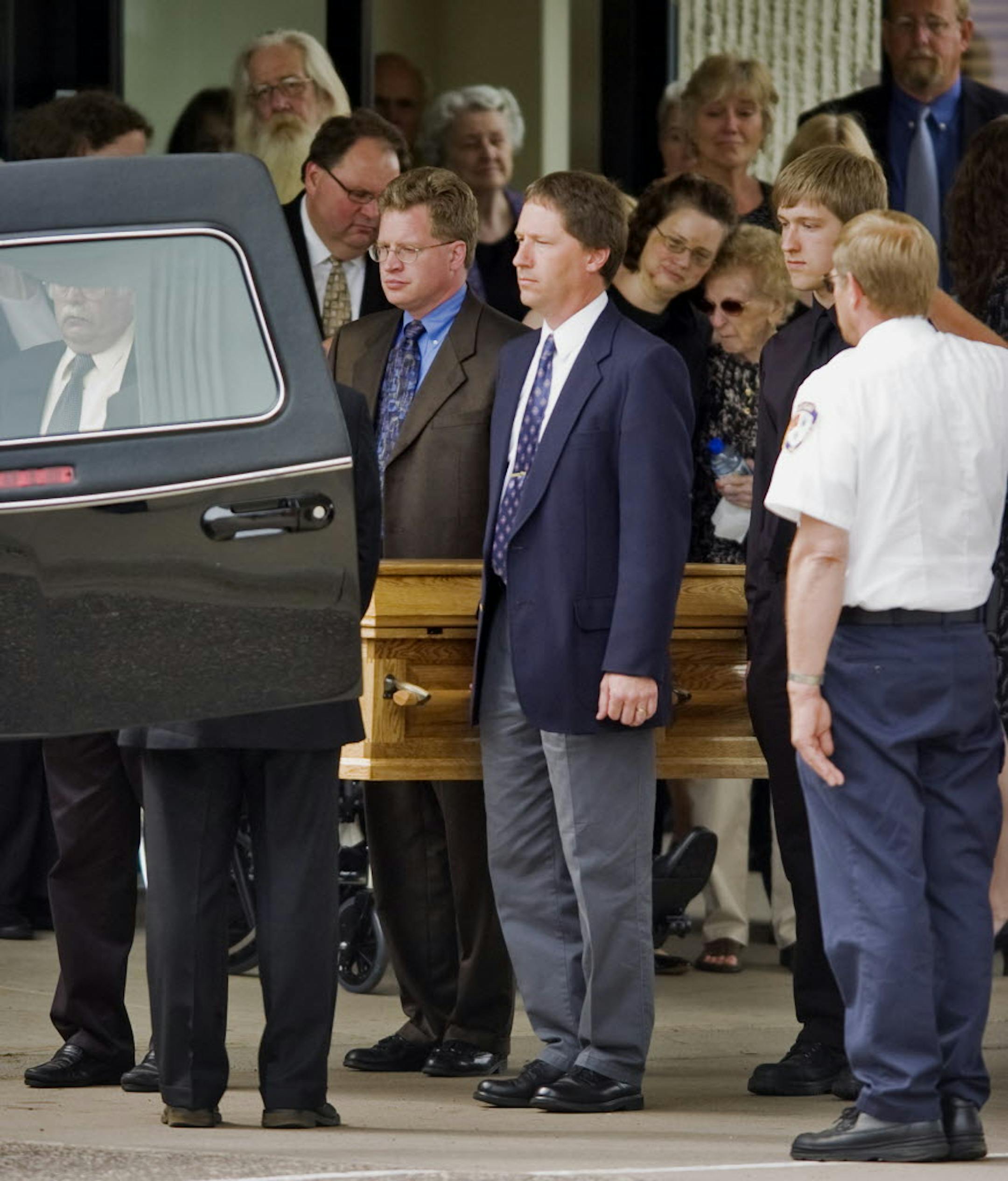 The casket bearing 2-year-old Nathaniel Prindle's body was carried to the hearse after a funeral service at Eagle Brook Church near White Bear Lake. In honor of Nathan's love of trains, a bright red Canadian Pacific locomotive was parked in attendance on nearby railroad tracks.