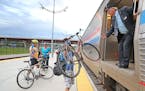 Amtrak Train Conductor Paul Trossen, cq, helped passengers lift their bikes onto the train, Monday, September 19, 2016 at the Union Depot in St. Paul,