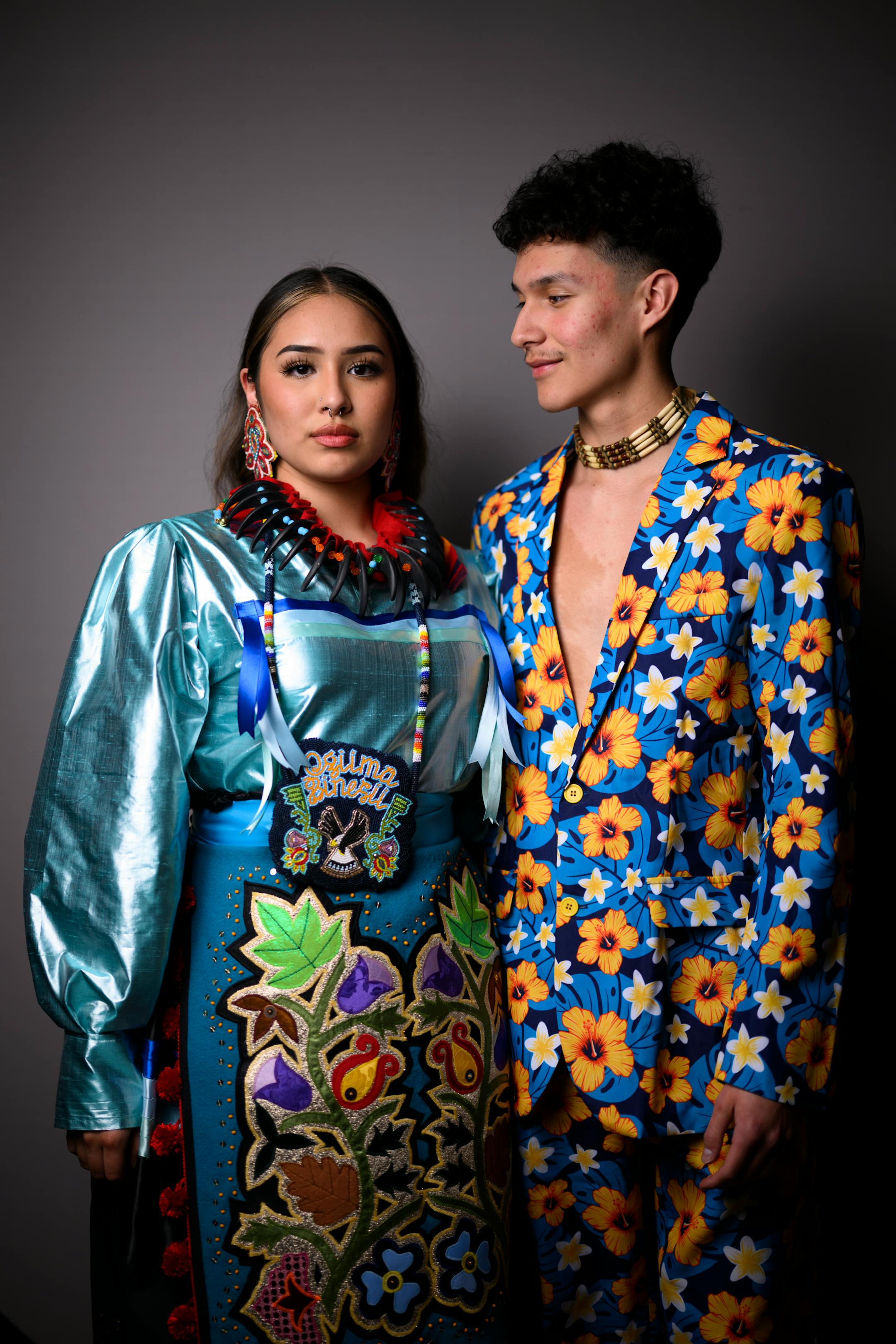 Snowy White and Cade Beaulieu stand for a portrait during "Northern Lights: A Native Nations Fashion Night." White's mother and grandmother are two of the fashion designers featured during the show. White is wearing a dress made her mother, Lavender Hunt.