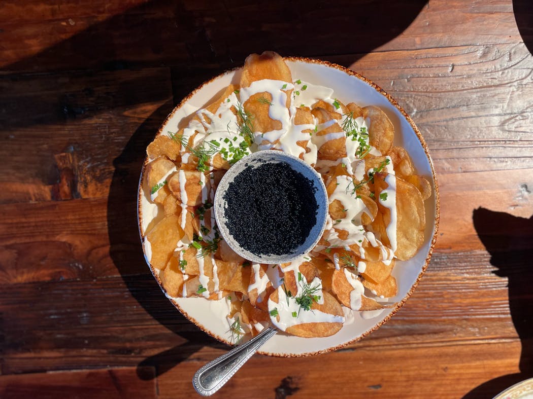 Thick potato chips with a caviar dip at Eagan’s Kitchen and Rail.
