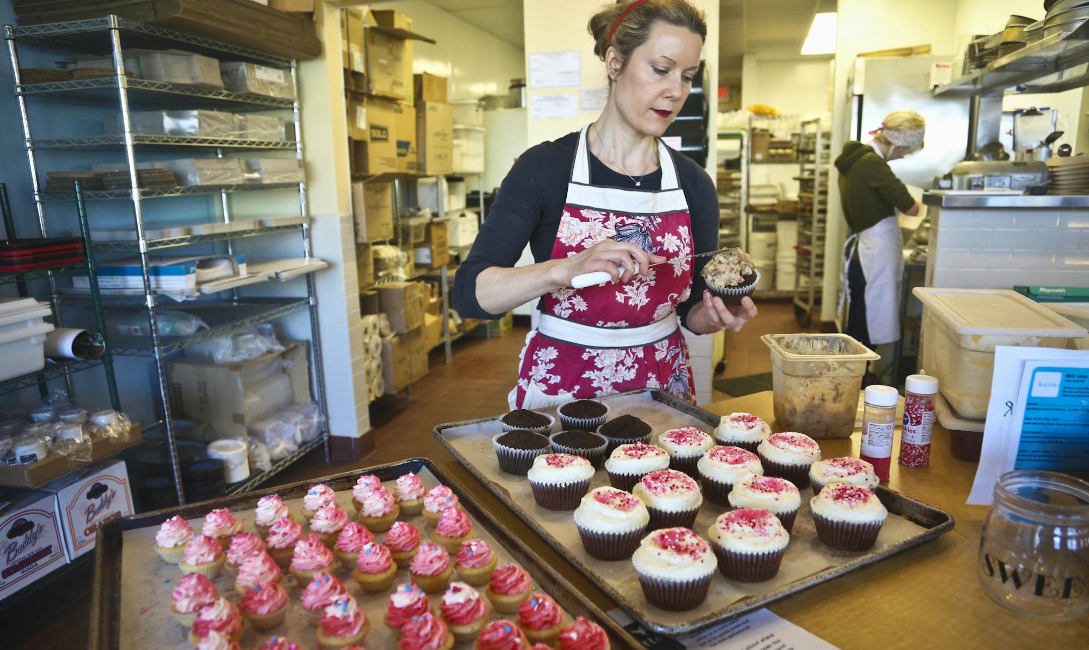 Head baker Amy Kovacs frosted cupcakes at Butter Bakery Cafe at the new location on Nicollet Avenue in Minneapolis, Minn. on Wednesday, February 13, 2013. ] (RENEE JONES SCHNEIDER reneejones@startribune.com)