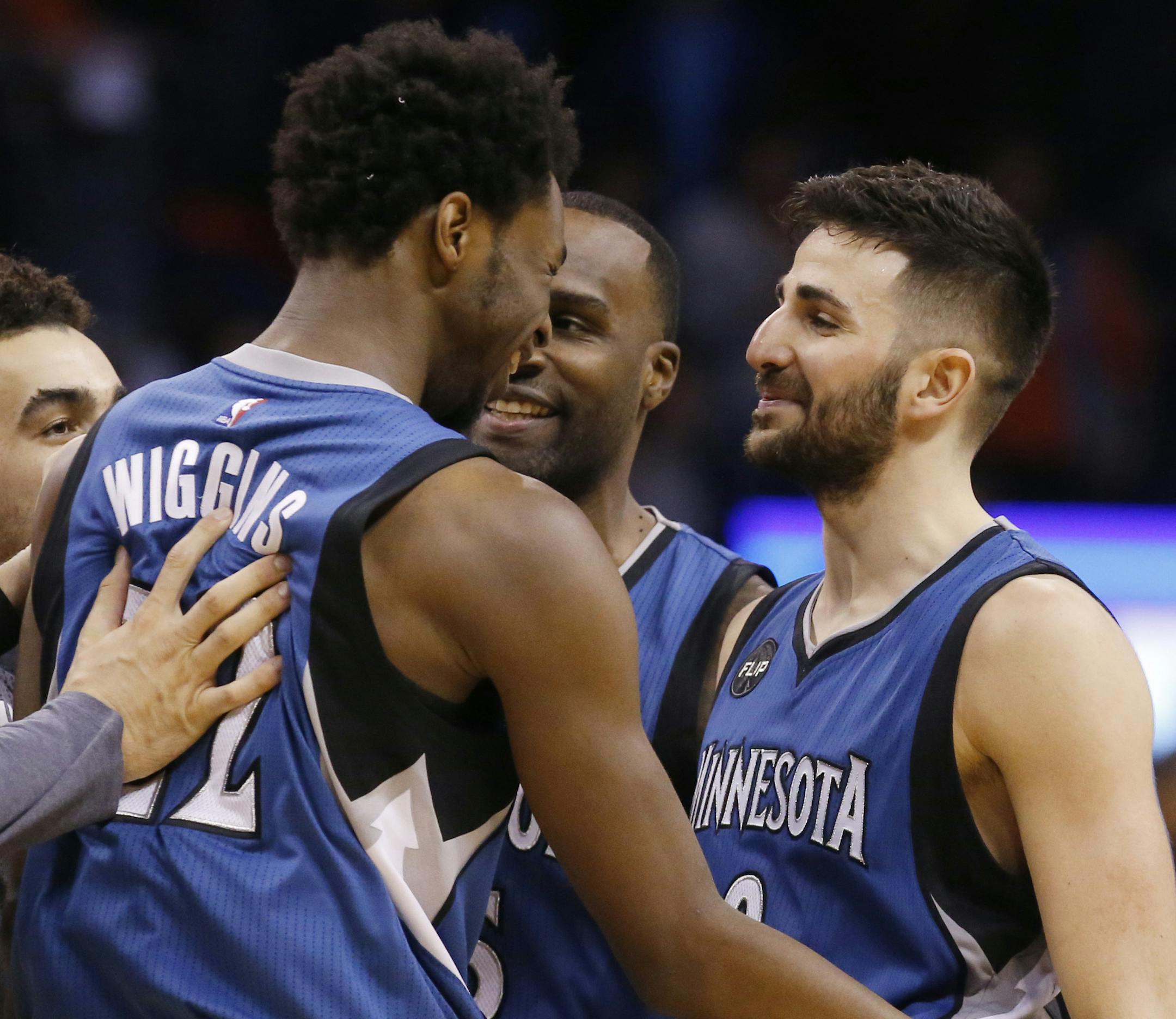 Minnesota Timberwolves guard Ricky Rubio, right, celebrates with teammate guard Andrew Wiggins, left, following an NBA basketball game against the Oklahoma City Thunder in Oklahoma City, Friday, March 11, 2016. Minnesota won 99-96. (AP Photo/Sue Ogrocki) ORG XMIT: OKSO107