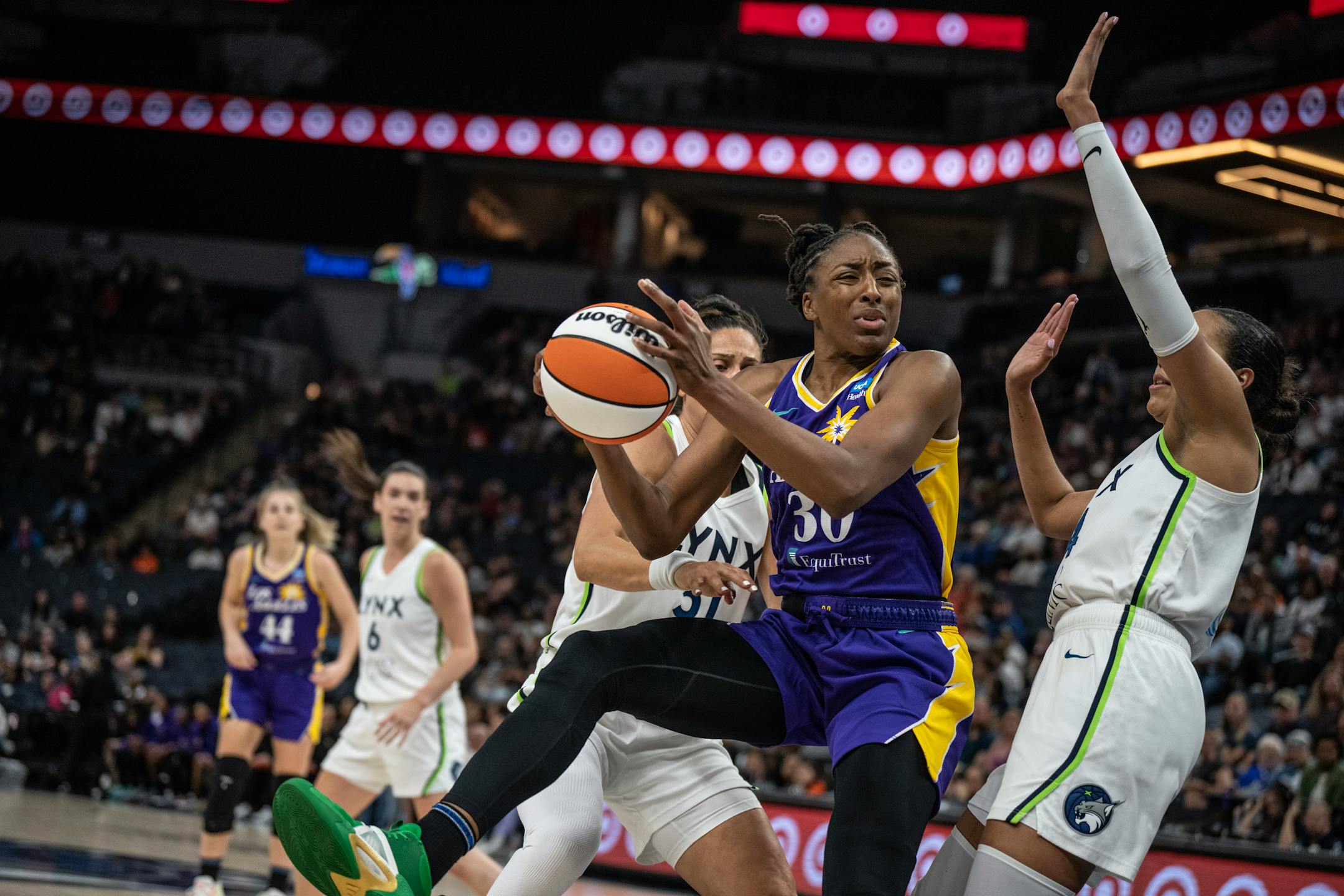Minnesota Lynx forwards Nikolina Milic (31), left, and Napheesa Collier (24) put pressure on Los Angeles Sparks forward Nneka Ogwumike (30) in the second half.
