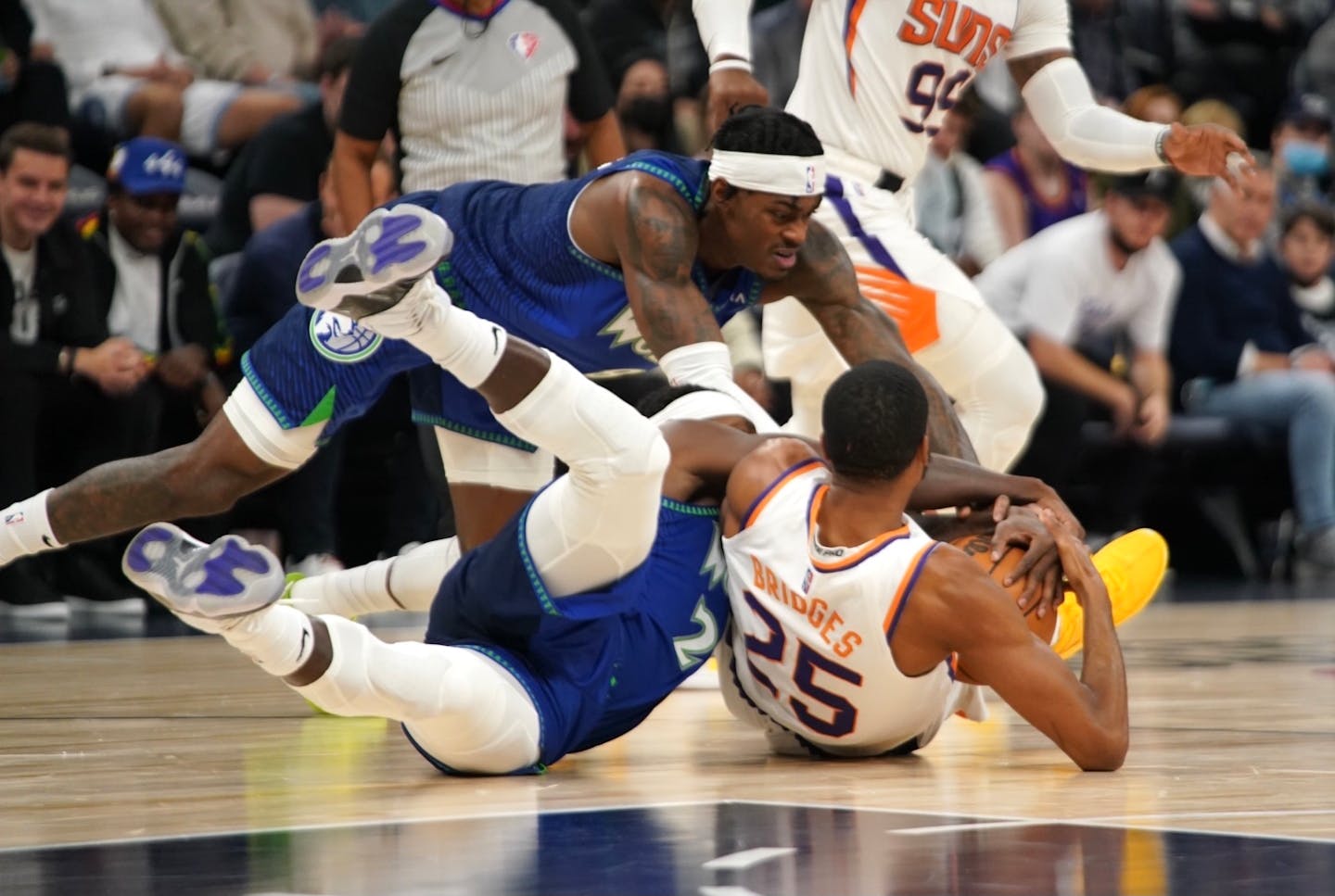 Timberwolves guard Patrick Beverley and forward Jarred Vanderbilt tumble to the ground with Phoenix guard Mikal Bridges on Nov. 15.