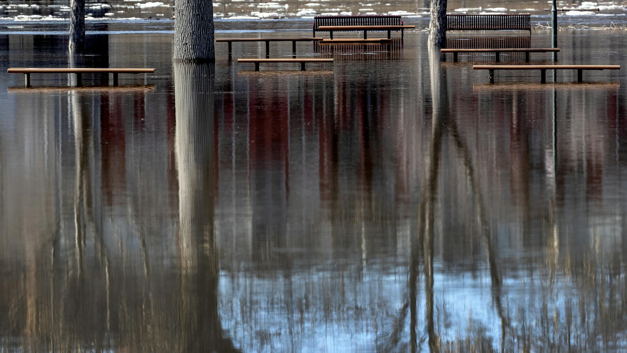 Partially submerged benches at Harriet Island Regional Park on Monday afternoon.