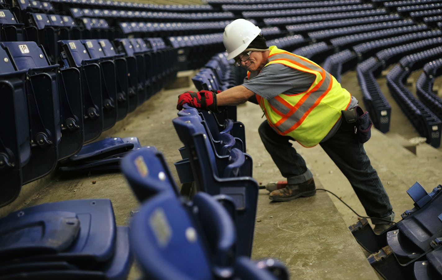 Johnny Tran helped remove seats from the Metrodome after the Vikings played their last football game ever at the facility, which is being torn down.