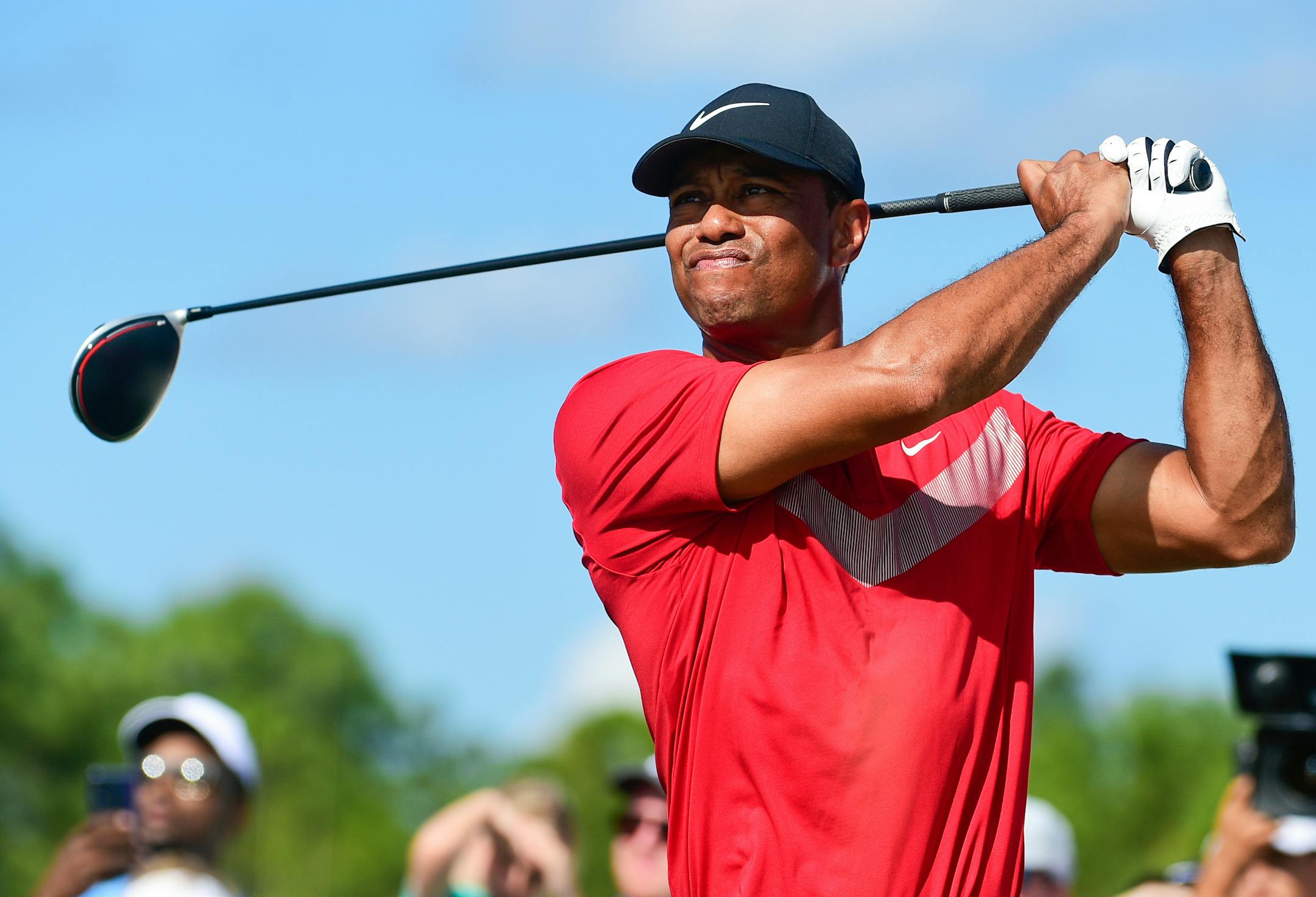 FILE - Tiger Woods follows his ball at the fourth tee during the last round of the Hero World Challenge at Albany Golf Club in Nassau, Bahamas, Saturday, Dec. 7, 2019. Tiger Woods has another loaded field for his Hero World Challenge in the Bahamas. Woods on Tuesday, Oct. 4, 2022, announced 17 players for the 20-man field, and all but four are from the top 21 in the world ranking. Still to be announced is whether the player at No. 1,195 in the world — Woods — will tee it up at Albany.(AP Photo/Dante Carrer, File)