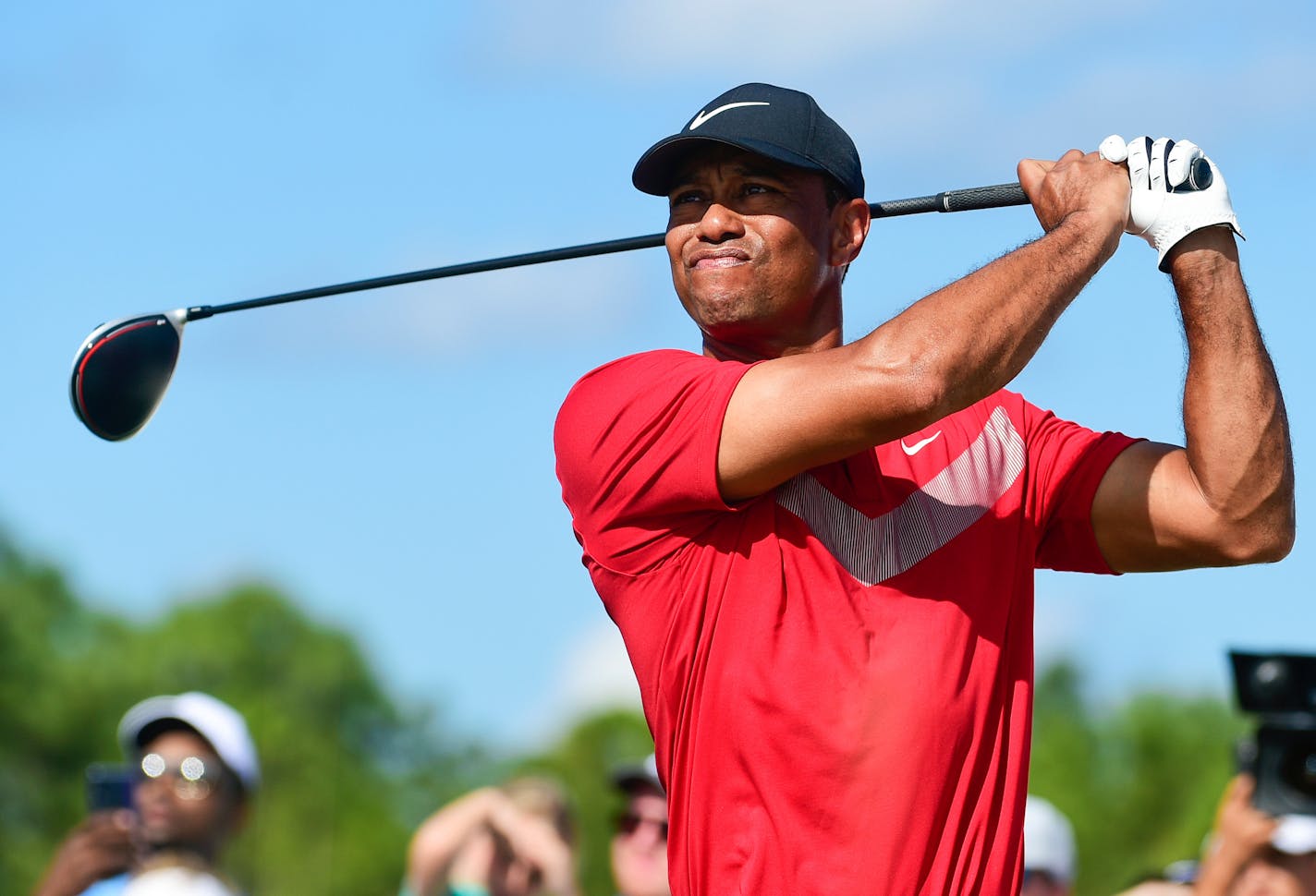 FILE - Tiger Woods follows his ball at the fourth tee during the last round of the Hero World Challenge at Albany Golf Club in Nassau, Bahamas, Saturday, Dec. 7, 2019. Tiger Woods has another loaded field for his Hero World Challenge in the Bahamas. Woods on Tuesday, Oct. 4, 2022, announced 17 players for the 20-man field, and all but four are from the top 21 in the world ranking. Still to be announced is whether the player at No. 1,195 in the world — Woods — will tee it up at Albany.(AP Photo/Dante Carrer, File)