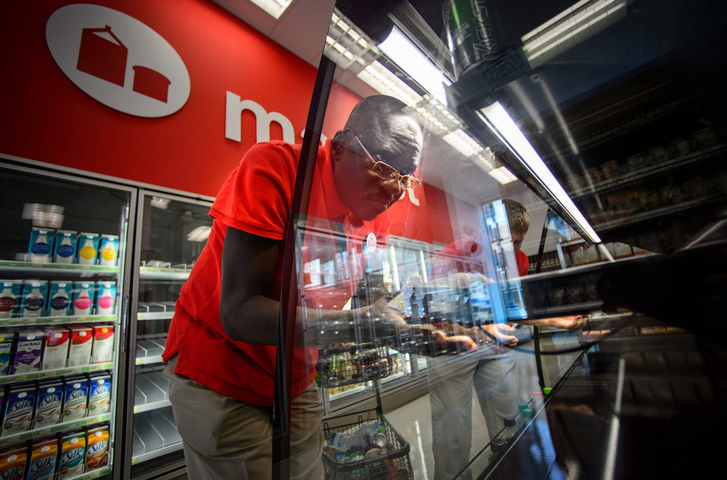 A Target employee assembles a soft drink display case in this file image. Target is adding more benefits for workers in both its stores and corporate offices. (Glen Stubbe/Minneapolis Star Tribune/TNS) ORG XMIT: 1334023