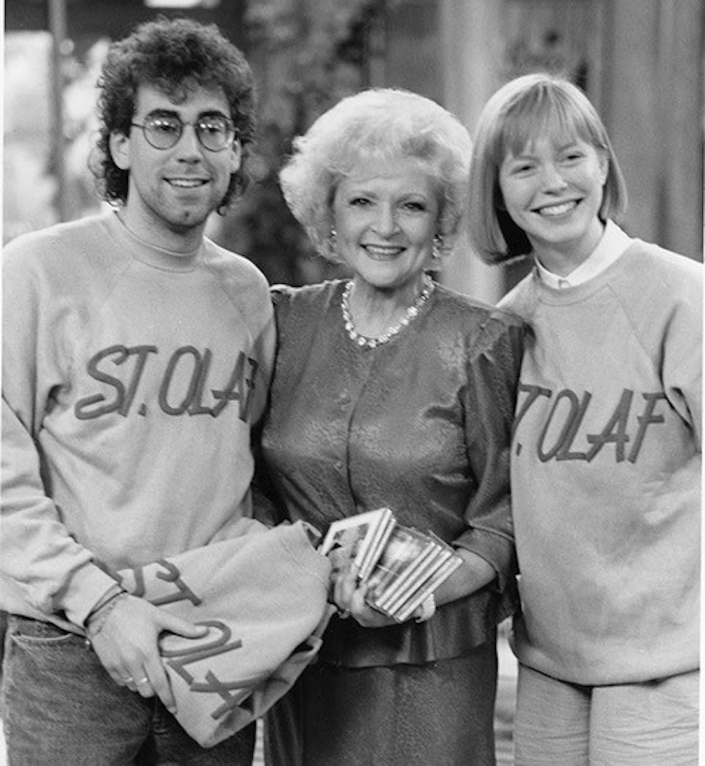 Betty White with St. Olaf College choir singers in 1989 when the choir visited Los Angeles and attended a taping of "The Golden Girls." White and co-star Rue McClanahan greeted the choir with a rendition of "Um Yah Yah!" — St. Olaf's fight song. credit: St. Olaf College Archives